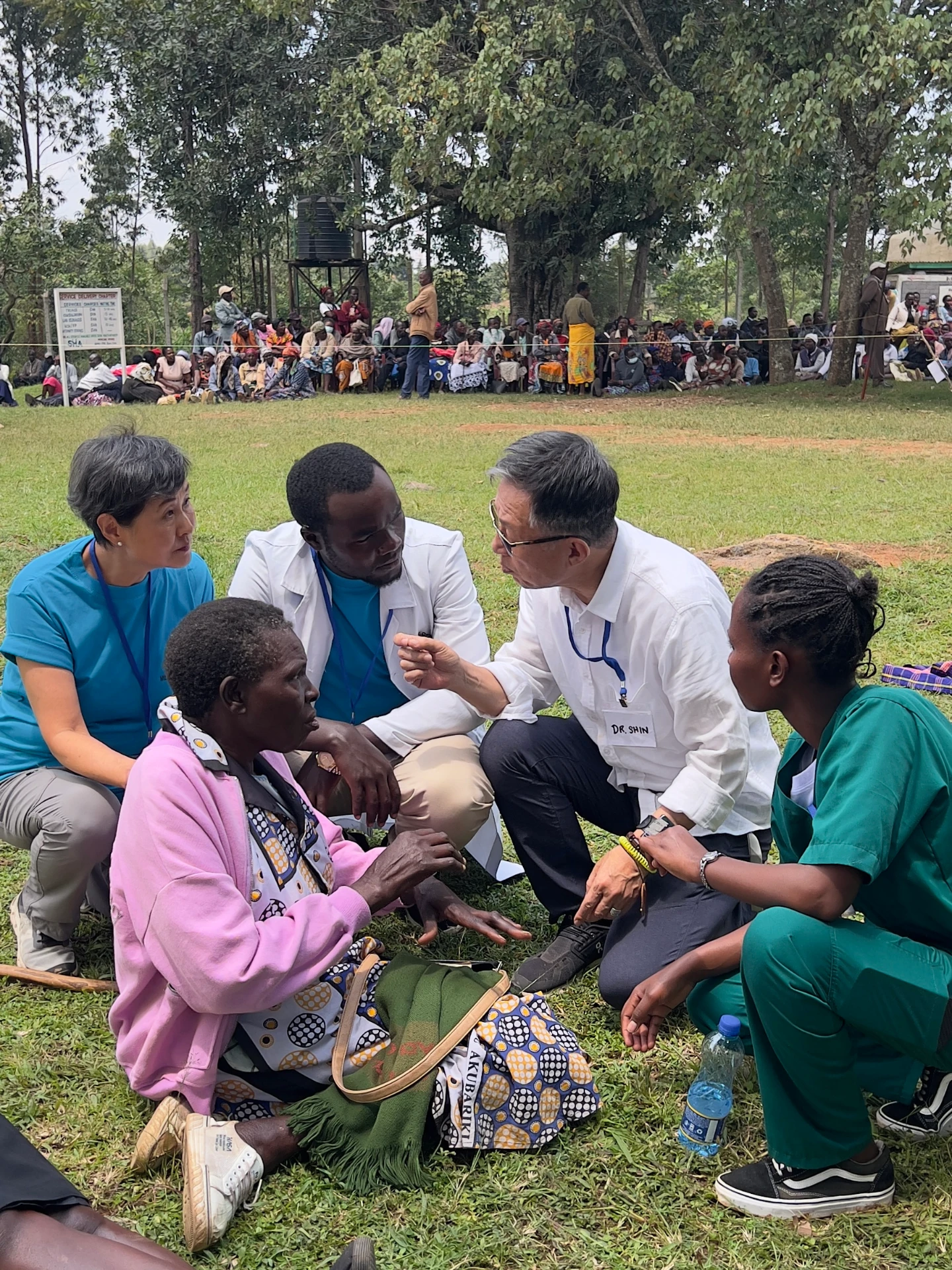 DOTRI volunteers caring for a patient at an outdoor medical mission clinic in Kenya